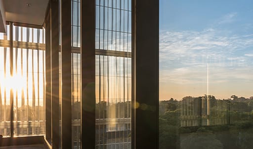 sunshine coming through glass window with view over city